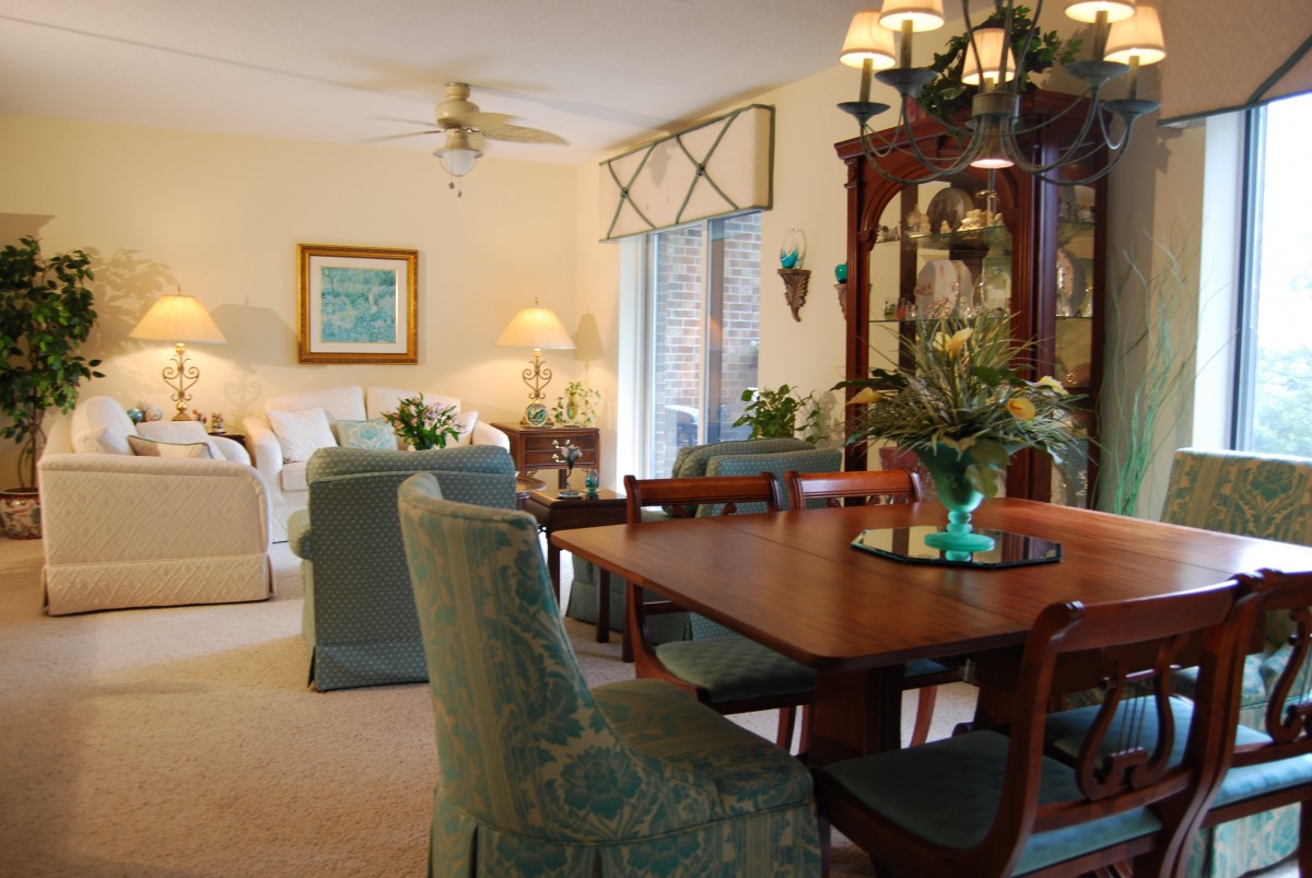 A cozy living and dining area with elegant furniture and soft lighting.