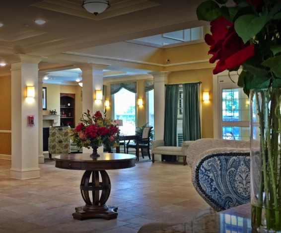 A beautifully decorated lobby with elegant furniture and floral arrangements.