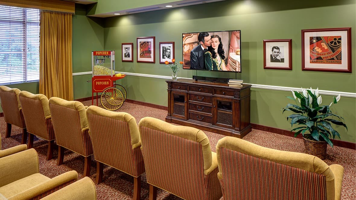 Cozy home theater with comfortable seating and a popcorn machine.