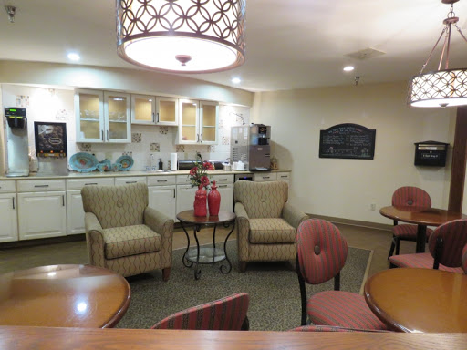 A cozy lounge area featuring comfortable chairs and a kitchenette.