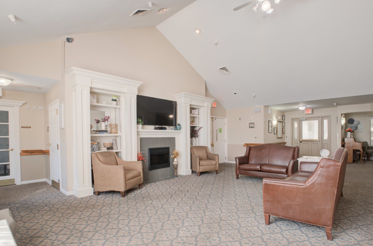A cozy living room with a fireplace, television, and comfortable seating.