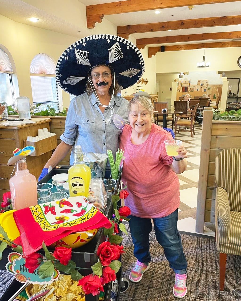 Two people celebrating indoors with festive decorations and food.