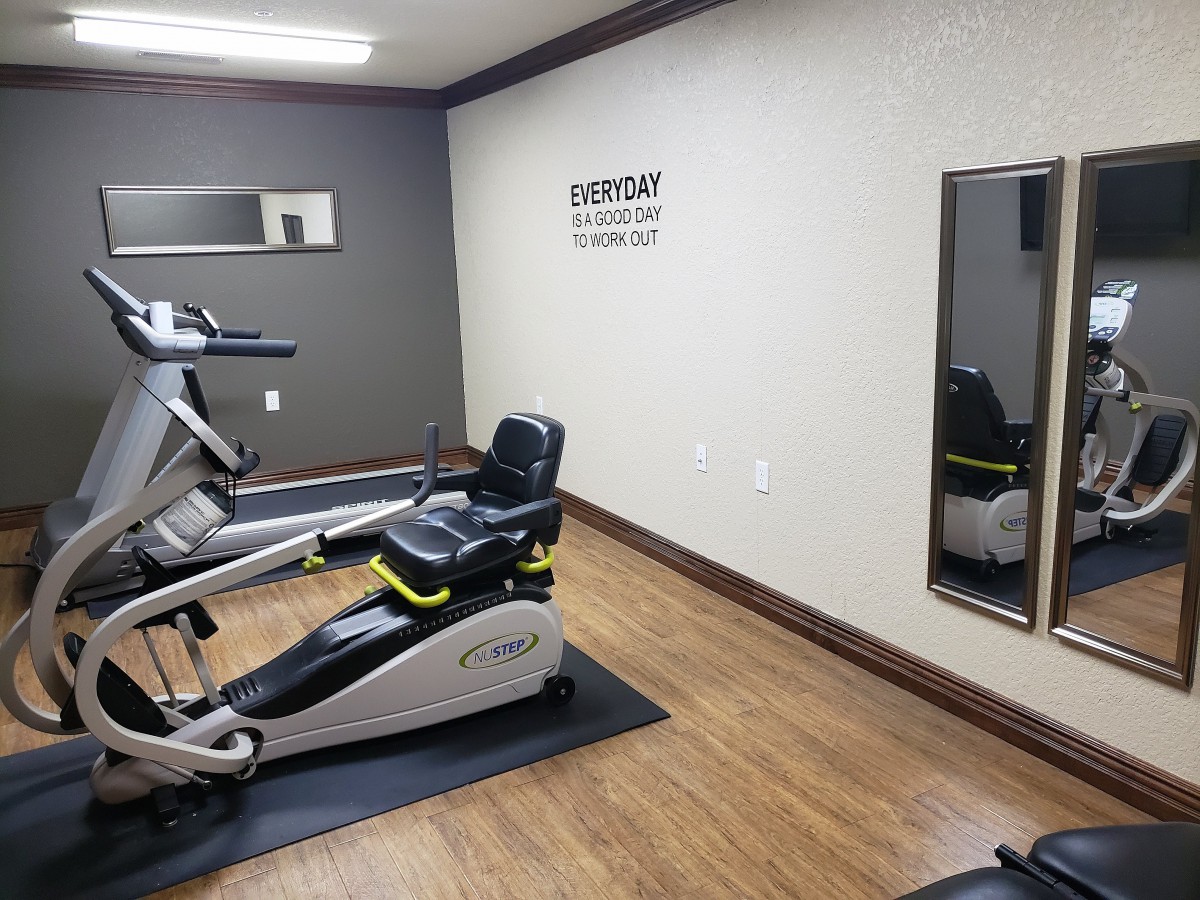 A small gym room featuring exercise bikes and mirrors.