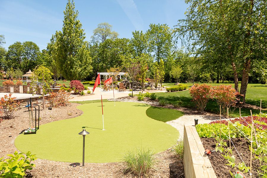 A beautifully landscaped garden featuring lush greenery and a winding pathway.