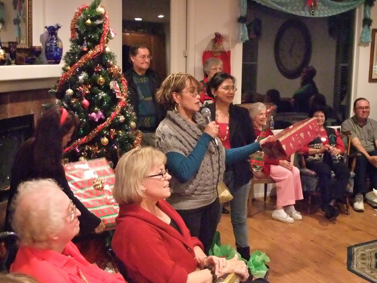 A family gathers around the Christmas tree for a holiday gift exchange.