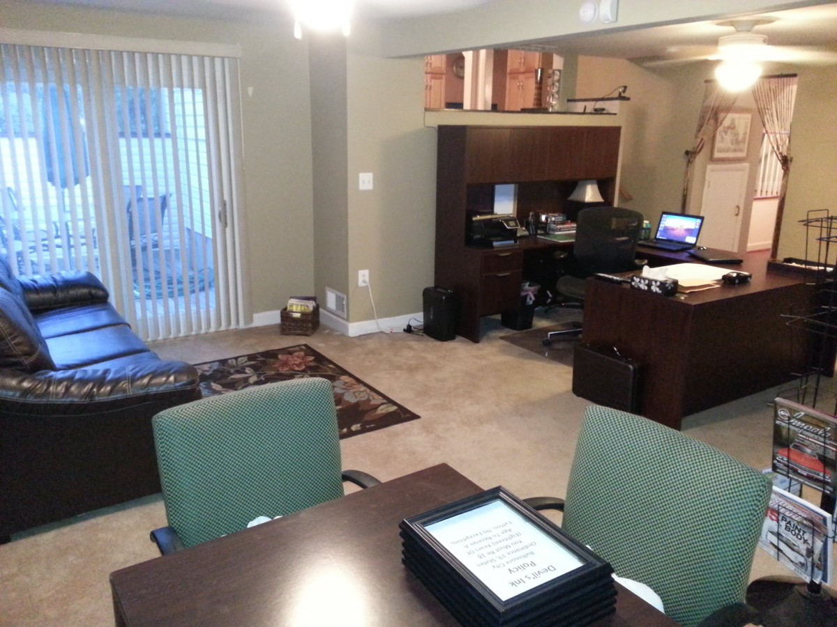 A well-organized home office with desks, chairs, and computer equipment.
