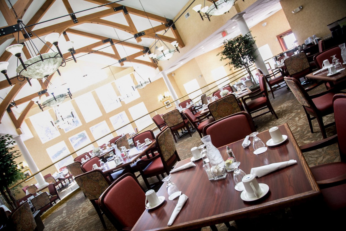 Elegant restaurant dining area with neatly set tables and warm lighting.