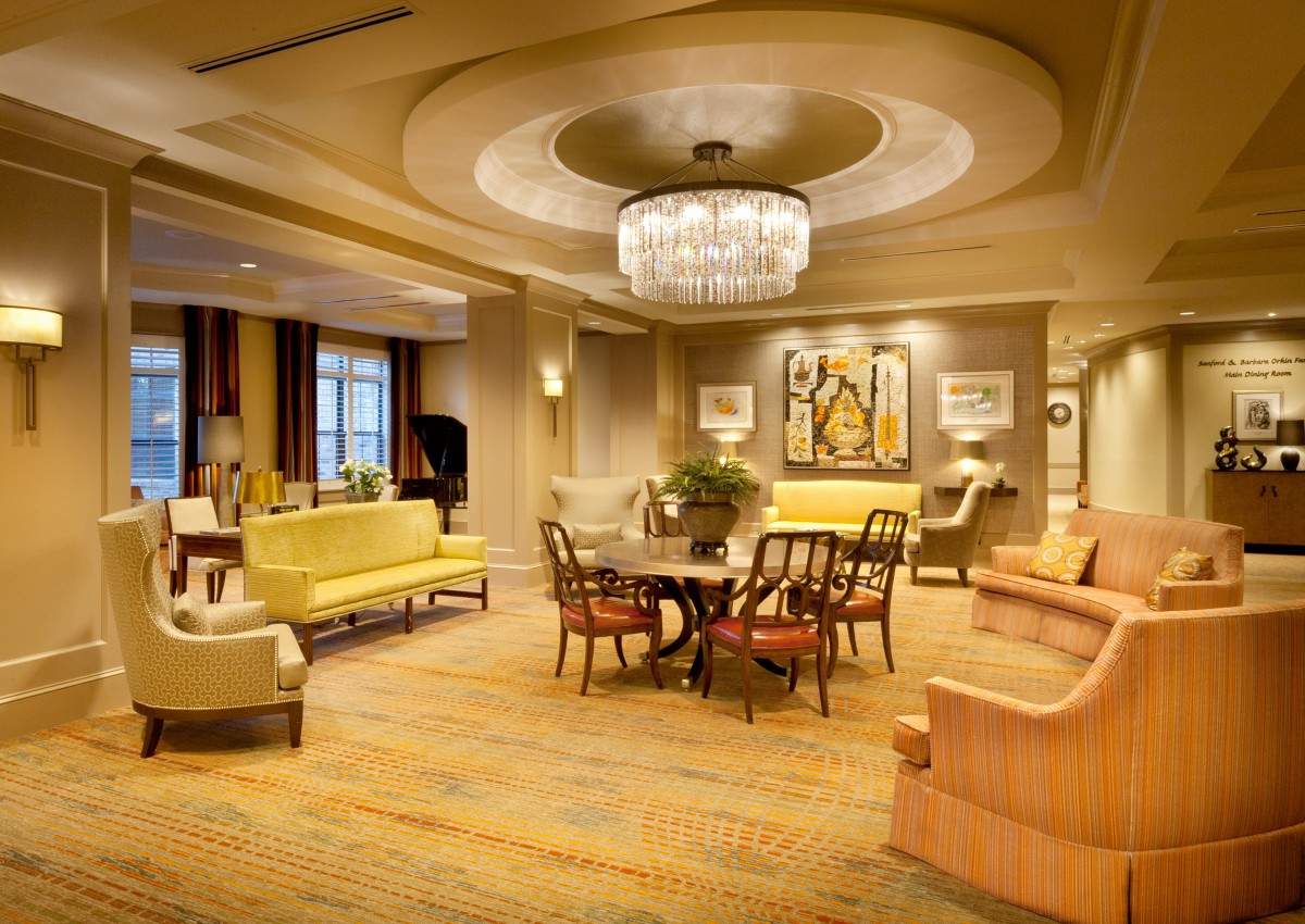 A luxurious living room featuring elegant furniture and a chandelier.