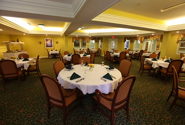 An elegant dining room with round tables set for a meal.