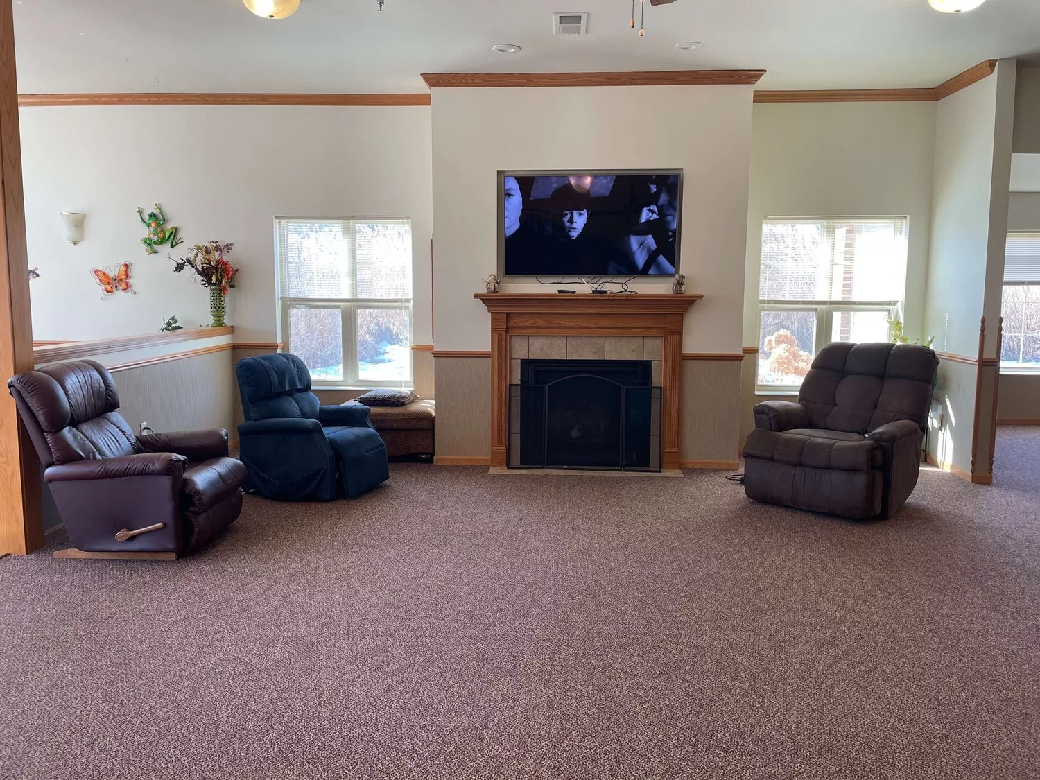 A cozy living room with a fireplace, television, and comfortable seating.
