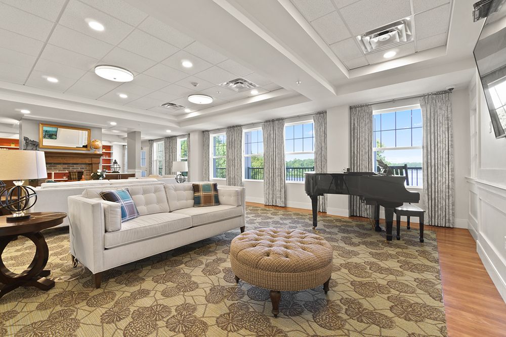 Elegant living room with a grand piano and comfortable seating.