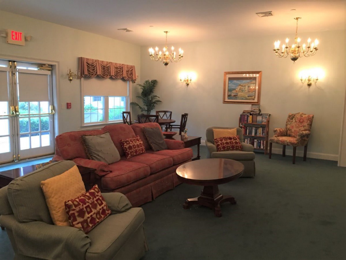 A cozy living room with traditional furnishings and warm lighting.