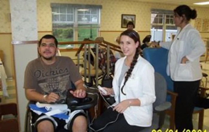 A therapist assists a patient during a rehabilitation session.