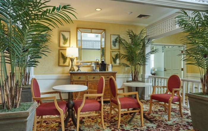 A cozy lobby area with seating, plants, and decorative elements.
