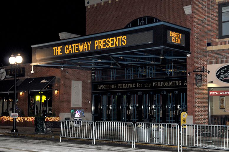 The Gateway theater entrance lit up at night.