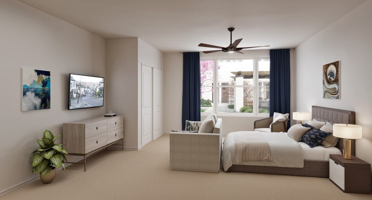 A modern bedroom featuring a bed, television, and ceiling fan with large windows and curtains.