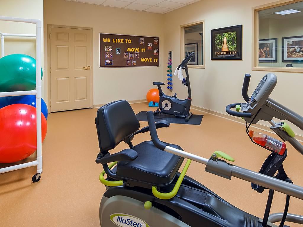 A small gym with exercise equipment including stationary bikes, set up for fitness activities.