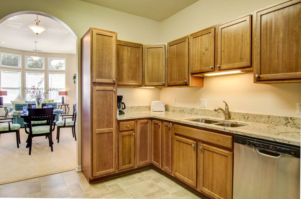 A cozy kitchen with wooden cabinets and modern appliances.