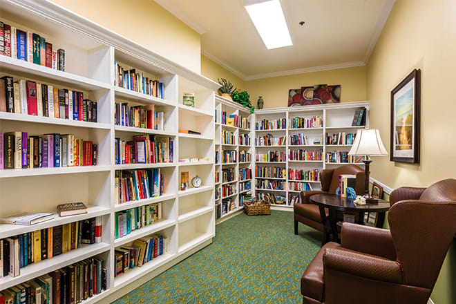 A cozy library corner with bookshelves and comfortable seating.