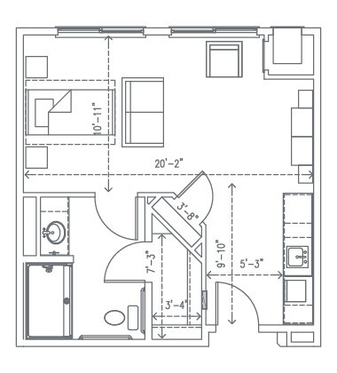 A compact studio apartment floor plan featuring a bedroom area, bathroom, and kitchen.