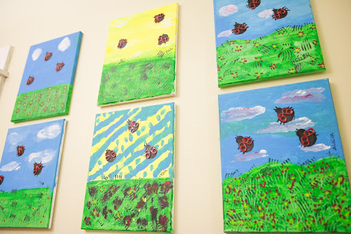 A vibrant display of abstract landscape paintings, showcasing a variety of colors and textures.