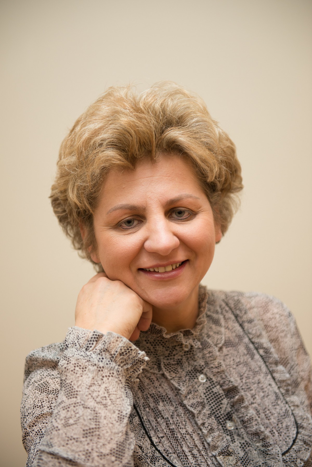 A woman smiling in a formal portrait.