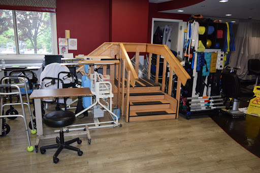 A well-equipped therapy room featuring a set of stairs for rehabilitation exercises.