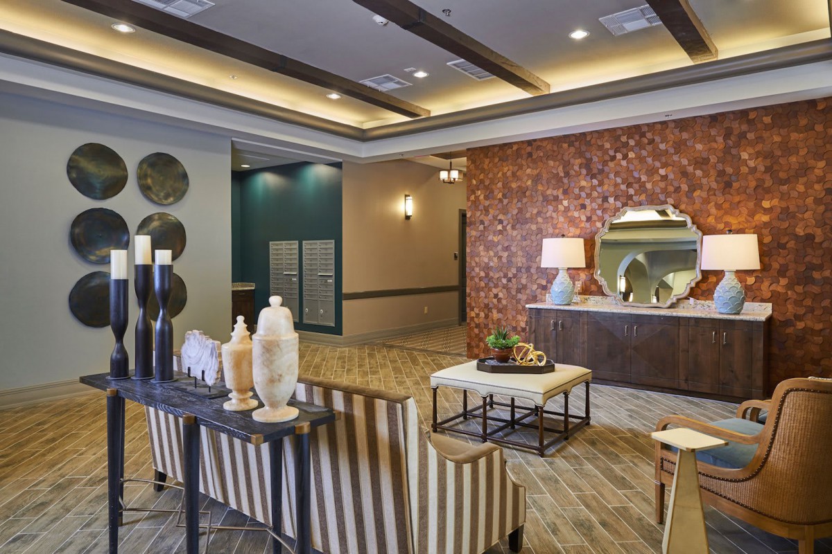 A modern lobby interior with stylish furniture and decor elements.