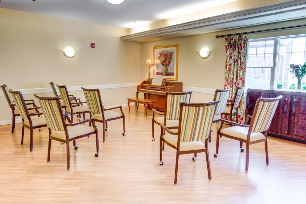 An empty indoor room with chairs arranged for a meeting.