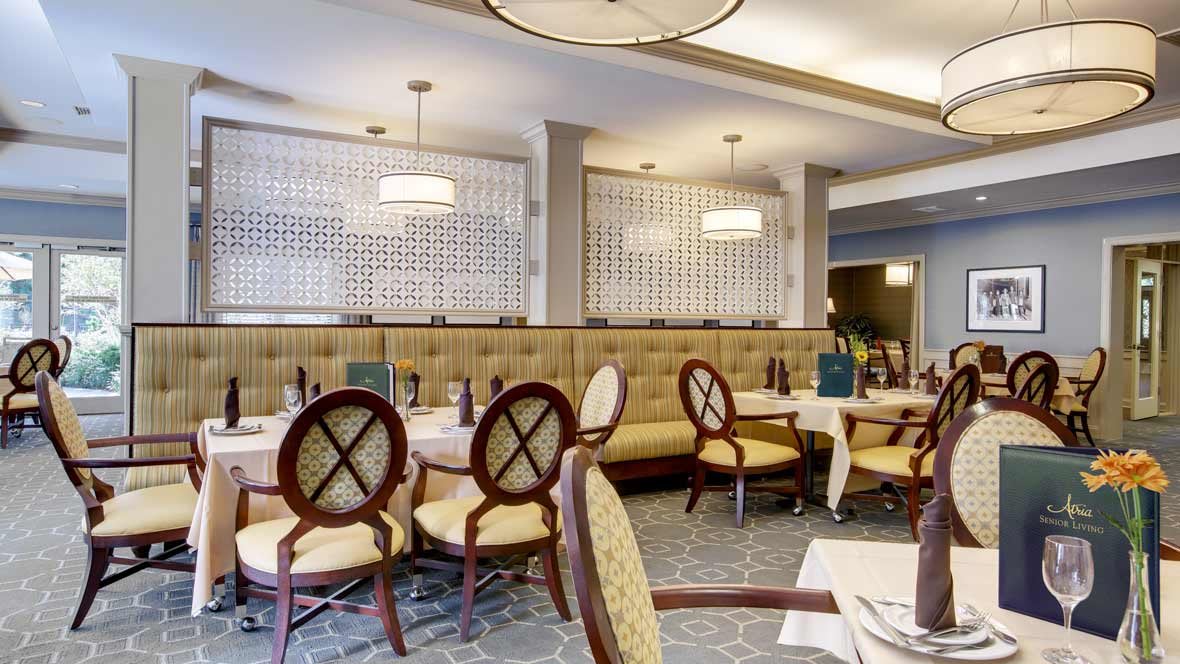 A cozy and elegantly designed restaurant dining area with neatly arranged tables and chairs.