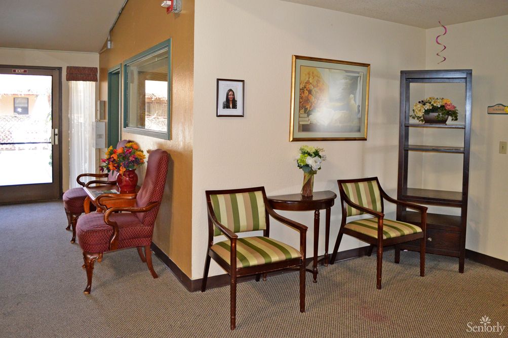 A cozy waiting room with chairs and a decorative setup.
