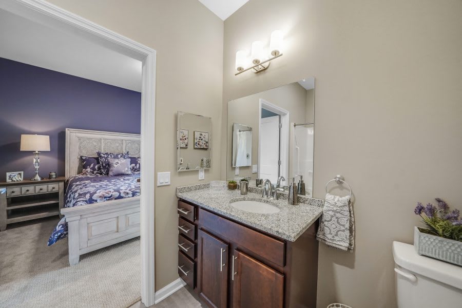 Modern bathroom with a vanity and large mirror.