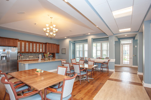 A modern kitchen and dining area featuring wooden furniture and ample natural light.