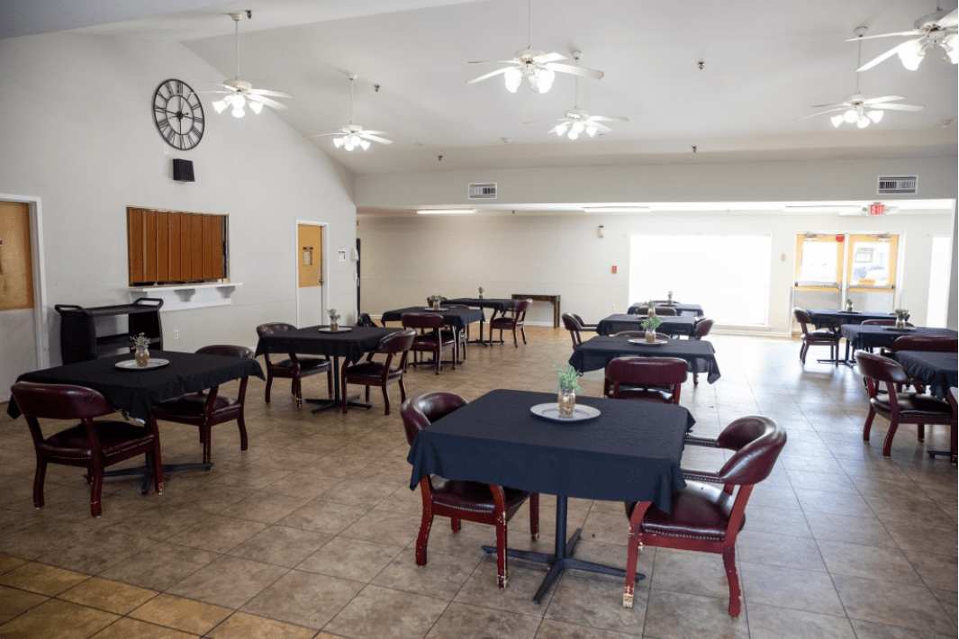 An empty dining area with neatly arranged tables and chairs, ready for guests.