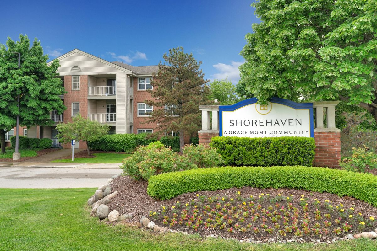 A view of the Shorehaven apartment complex with landscaped gardens and a prominent entrance sign.