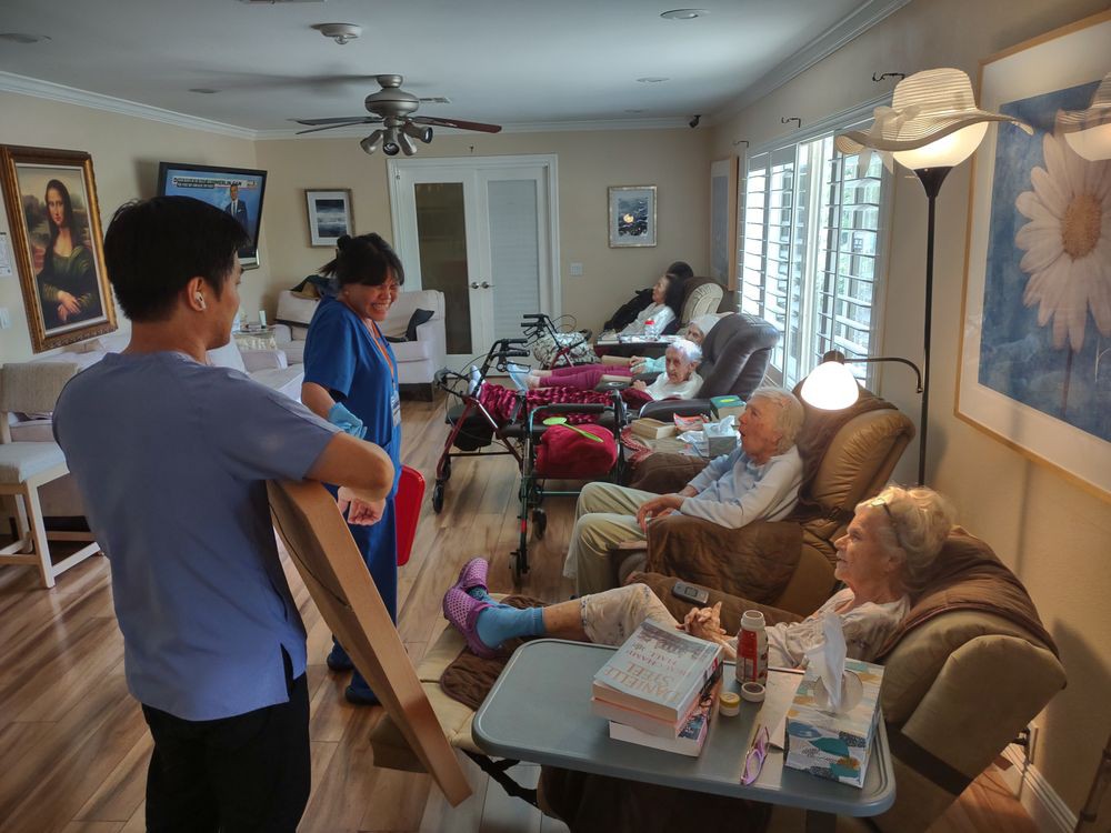 Caregivers attending to senior citizens in a nursing home setting.