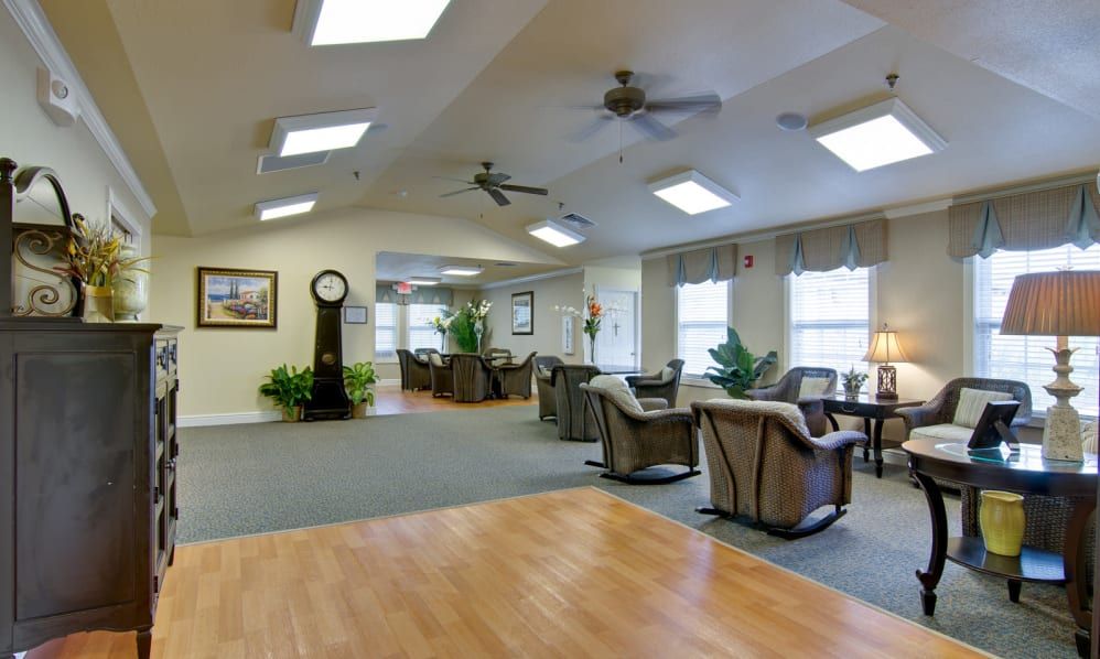 A spacious, brightly lit living area with comfortable seating and indoor plants.