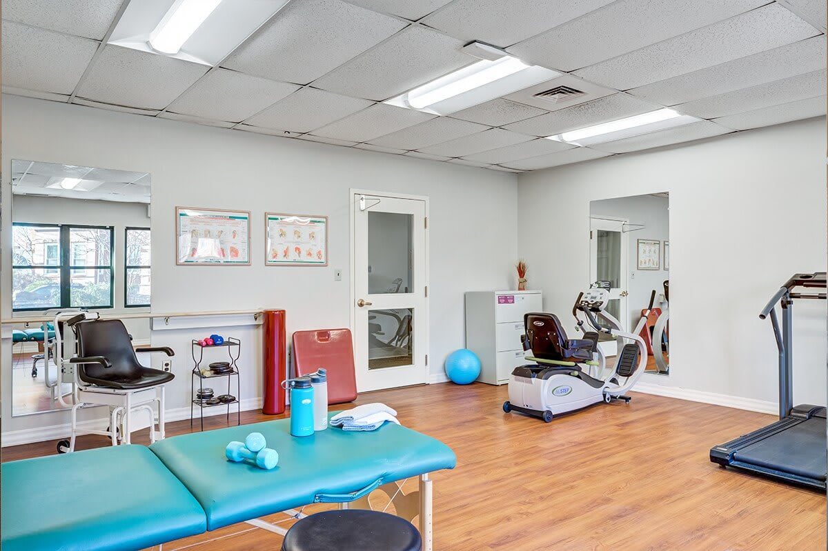 A physical therapy clinic with exercise equipment and treatment areas.