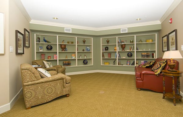 A cozy living room with built-in shelves and comfortable seating.