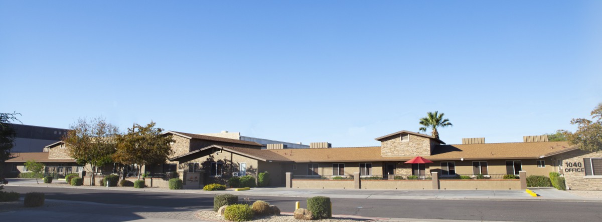 A desert commercial building with a clear blue sky in the background.