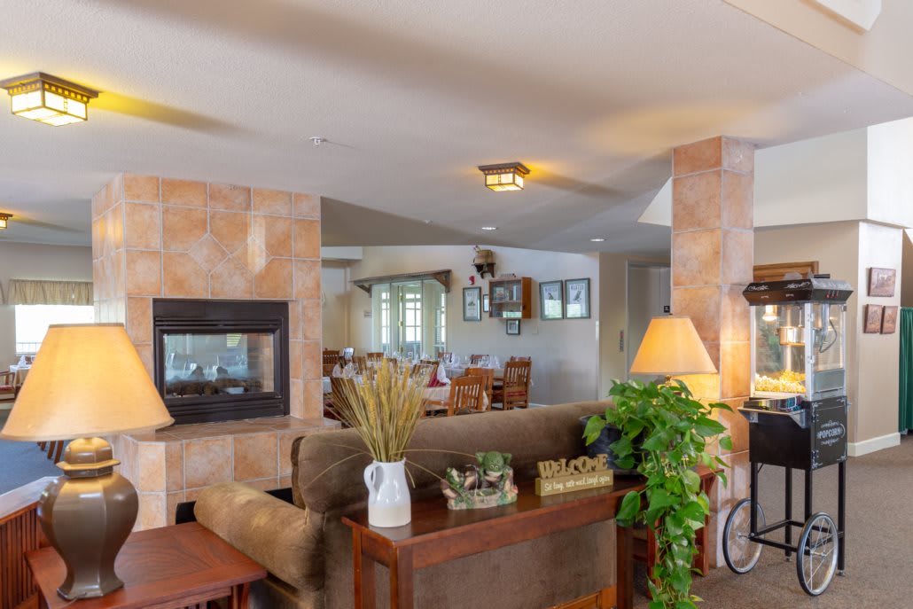 A cozy living room with a fireplace, sofa, and stylish decor.