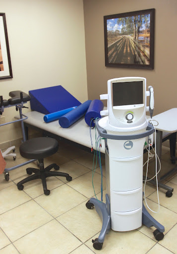 A therapy room equipped with various rehabilitation tools and medical devices.