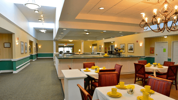 A well-lit dining area with neatly arranged tables and chairs, creating an inviting restaurant atmosphere.
