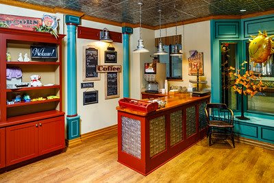 A vintage-style cafe interior with a colorful counter and decorative elements.