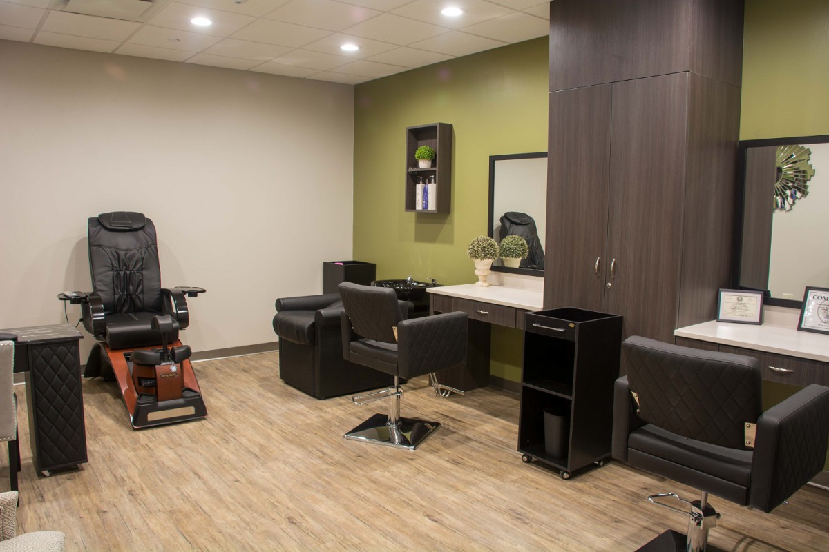 A modern and well-equipped salon interior with stylish furniture and mirrors.