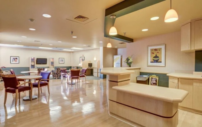 A well-lit lobby with a seating area and a reception desk.