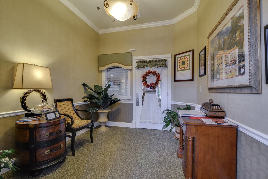 A cozy office waiting area with decorative elements and plants.