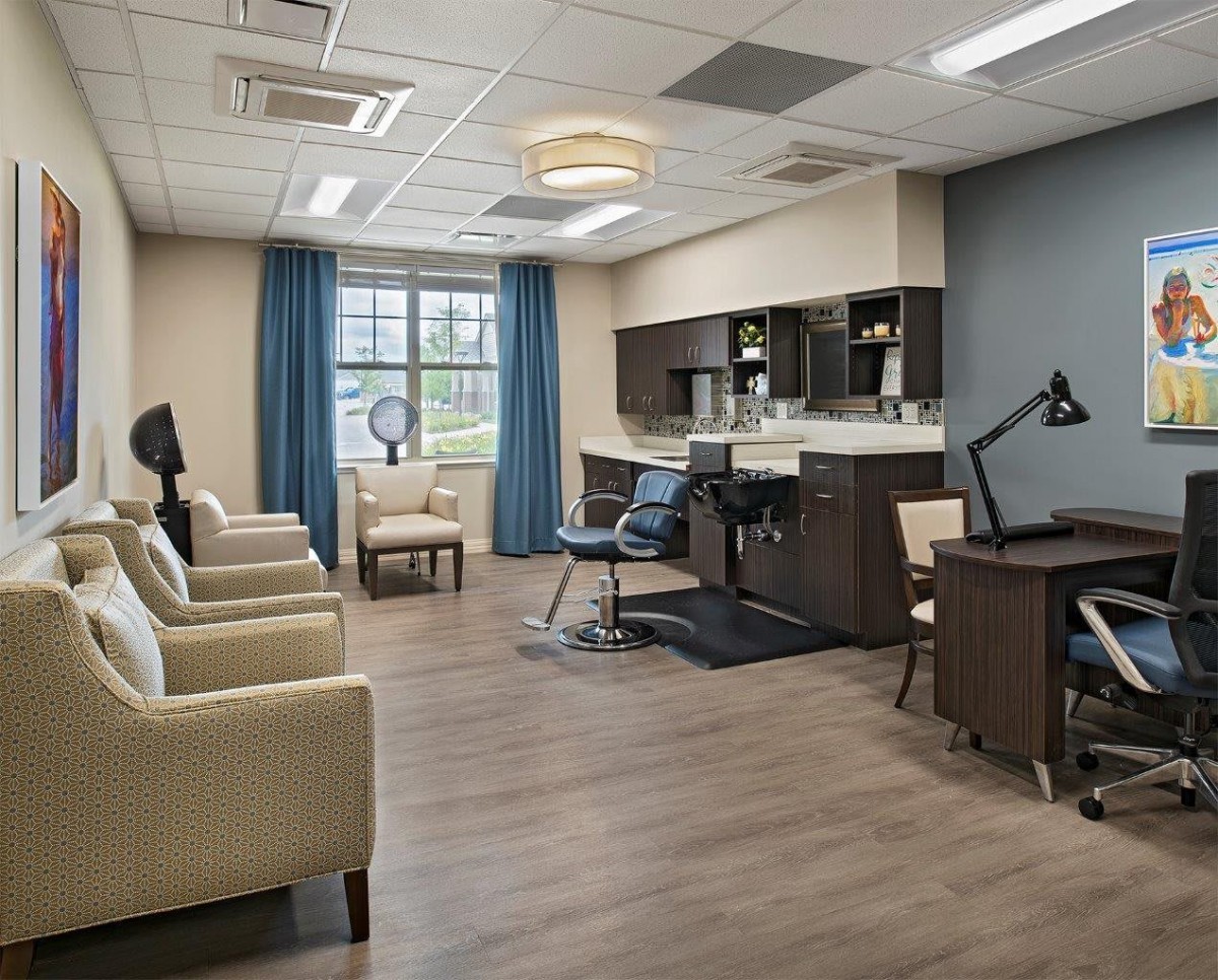A modern salon interior with comfortable seating and hairdressing stations.