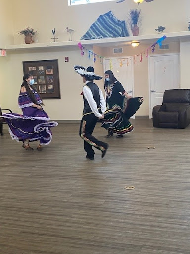 A vibrant display of traditional dance, showcasing rich cultural attire and lively movements.