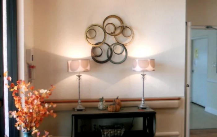 A stylish interior setup featuring wall art and illuminated lamps on a console table.